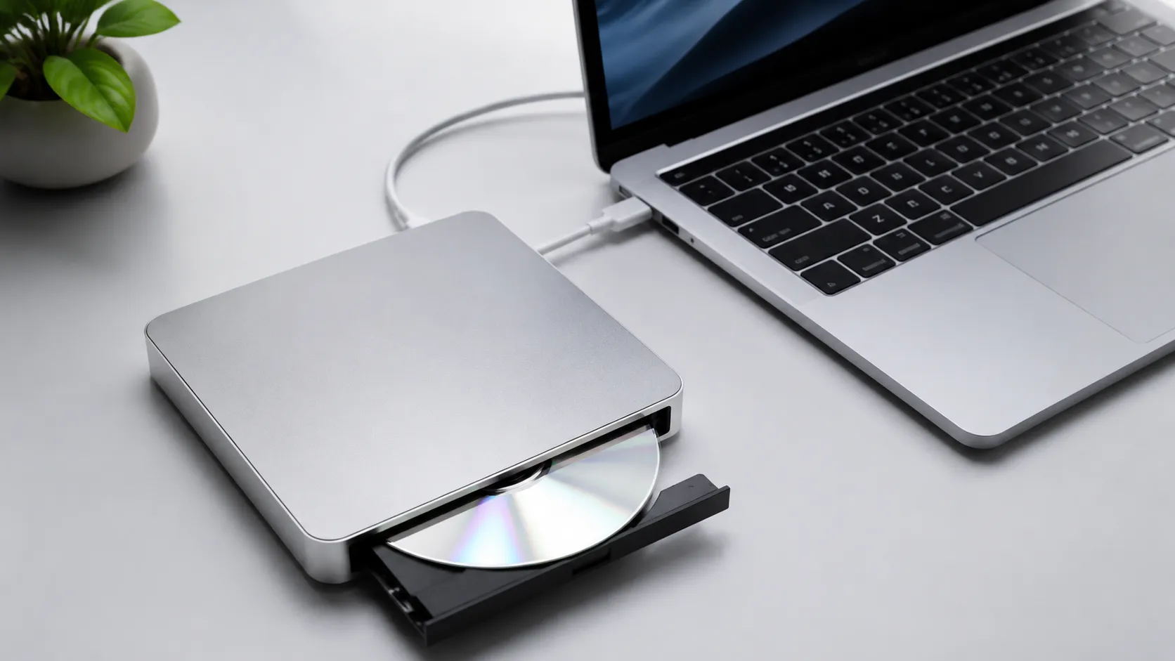 External USB optical drive connected to a MacBook Pro for burning DVDs on Mac